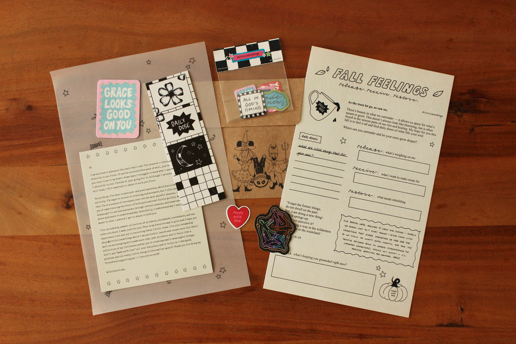Stationery items including cards, stickers, and a letter on a wooden surface